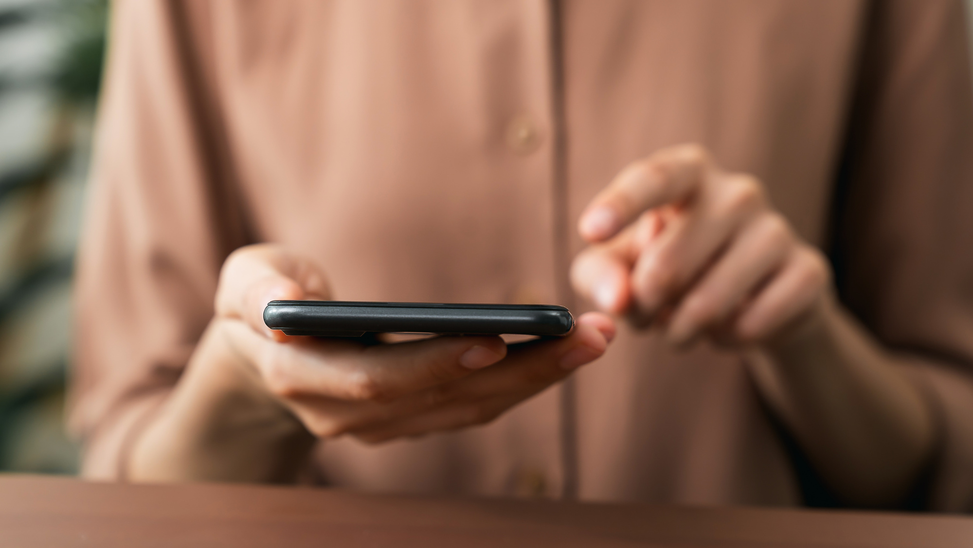 Hand holding smartphone with using social media on internet.